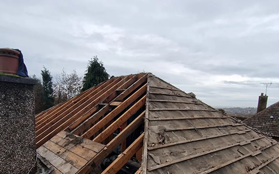 A roofer carrying out repairs on a roof